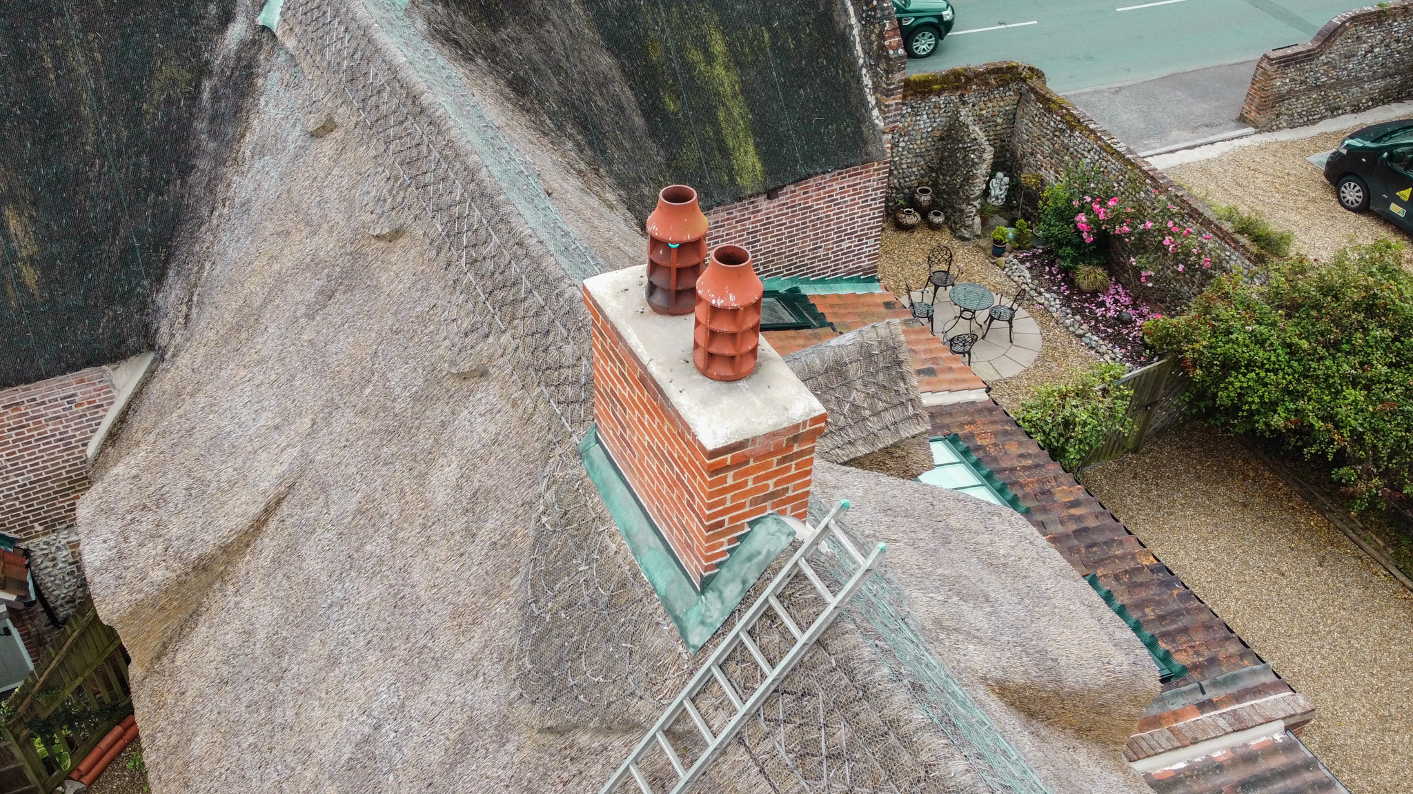 Aerial view of a chimney on a Norfolk thatched property being inspected by Watmore's Woodburners chimney sweep